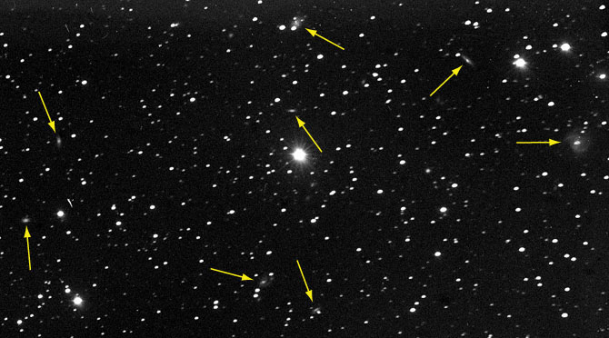 detail of 1899 plate of NGC 891 showing background galaxies